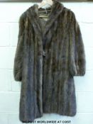 A three-quarter length, lined, vintage fur coat labelled Chas.