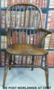 An elm seated Windsor armchair with carved stretcher