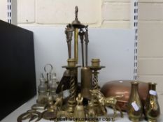 A quantity of brass items to include a companion set, twist design candlesticks,