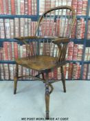 An elm seated Windsor armchair with carved stretcher
