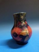 A Moorcroft vase in the Pomegranate pattern, 12cm tall.