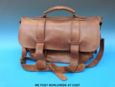 A vintage brown leather Messenger bag with multiple compartments and shoulder strap