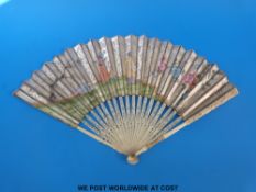 A 19thC Chinese carved and pierced fan with hand decorated figural garden scene