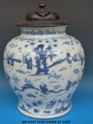 A large Chinese blue and white jar with decoration of various immortal figures and pierced wooden