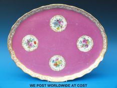 An oval ceramic tray with floral cartouches and Vienna beehive mark to base (42cm long)