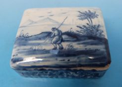 A Delft blue and white patch box decorated with landscape scene with figure,