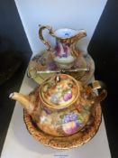 A collection of ceramics hand-painted with fruit,