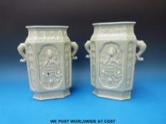 A pair of 19thC Chinese celadon vases with moulded decoration of Guanyin sitting on a lotus leaf