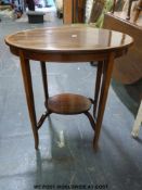 A crossbanded oval mahogany table with undershelf (max diameter 66 x h72)