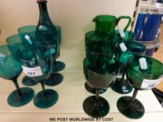 A Mary Gregory green glass jug, six wine glasses,