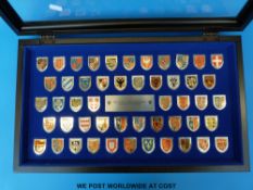 A display box containing 50 coats of arms of great monarchs of history from the Heraldry Society of
