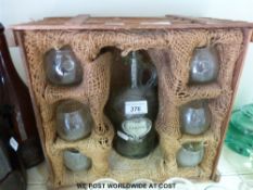 A vintage Cognac bottle and glasses in wooden crate,