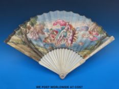 A 19thC bone fan, the guard sticks carved with male and female figures in 19thC dress.