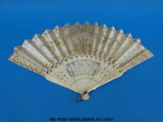 A 19thC bone folding fan with carved, pierced,
