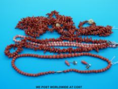 A coral necklace with spherical beads of angel skin colour together with another coral necklace and