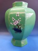 A large Masons' vase of hexagonal form decorated with oriental figures on a green ground (33cm