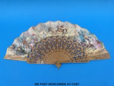 A carved and pierced Spanish sandalwood fan with inset cut steel decoration and hand painted