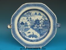 An 18thC Chinese blue and white hot water plate with landscape and pagoda scene (23cm diameter)