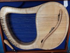 A cased fully chromatic 35 string soprano lyre in sycamore by Sophia Ltd,