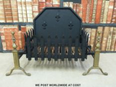 A cast iron fire grate and back with brass dogs