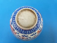 A 19thC Chinese blue and white bowl with red dragon decoration (12.