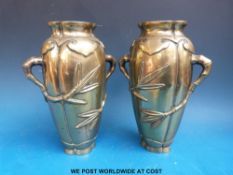 A pair of 18th/19thC Chinese bronze vases with relief bamboo handles and character mark to base
