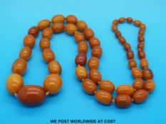 A graduated amber necklace of 52 oval beads, the largest 3.5 x 2.5cm, the smallest 0.