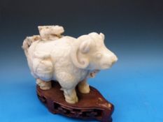 A Chinese jadeite archaistic figural lidded vase in the form of an ox with areas of dark green