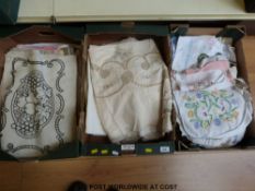 A collection of embroidered linen, cushion covers, chair backs, tablecloths,