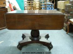 A mahogany 19thC drop leaf sofa table on faceted pedestal and quatrefoil base (length 94cm)