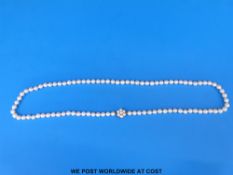 A pearl necklace with 9ct gold cluster clasp
