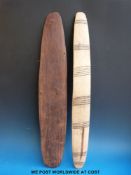 A carved Aboriginal wooden shield with geometric line carved decoration together with another light