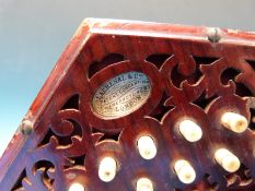 A c1926 Lachenal 21 key concertina in C/G with rosewood fretworked ends,