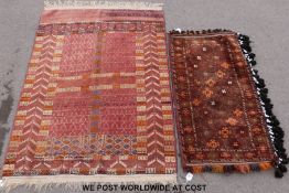 A silk rug with geometric and herring bone design on pink ground,