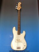 An Encore bass guitar in cream finish