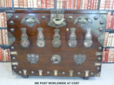 A Chinese blanket chest with metal mounts opening to reveal drawers inside with certificate of