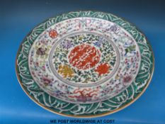 A large Chinese charger with gilt rim and all over decoration of symbolised stylised floral pattern,