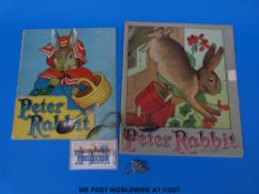 Two Charles Graham & Co Peter Rabbit books, three Peter Rabbit child's spoons,