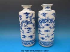 A pair of 19thC Chinese blue and white cylindrical vases with inverted rim decoration of dragon