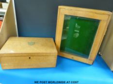 An oak display cabinet with hinged door,