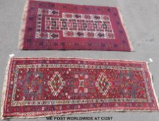 Two wool rugs on dark red ground with geometric design,