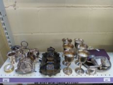 A plated egg cruet and toast rack, brass ink well, goblets,