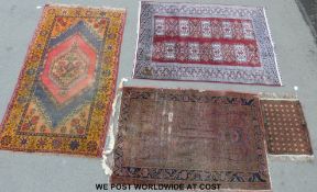 Three wool rugs in geometric design, one in Autumn colours, one on dark red ground,