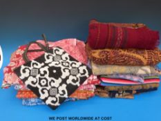 A collection of textiles to include woven silk saris, Kashmir embroideries and others from Nepal,