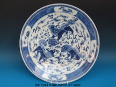 A 19thC Chinese blue and white charger decorated with three Fu dogs,