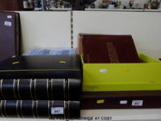 Two albums of greetings postcards together with various hold up to the light examples,