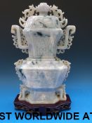 A Chinese pale mottled lavender and apple green jadeite vase and cover of flattened form,