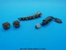 A Chinese white metal finger ornament together with a pair of earrings and a vase-shaped bottle