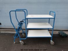 A three tier trolley with steps to one side