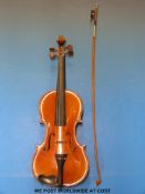 A cased violin with Stradivarius label